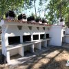 Barbecue in muratura in un'area verde.