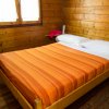 Camera con letto matrimoniale e lenzuola arancioni.