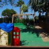 Playground with playhouse and swings.