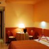 Una camera d'albergo accogliente con letto, lampada e tavolino.