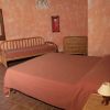 Camera da letto con letto matrimoniale e pareti arancioni.